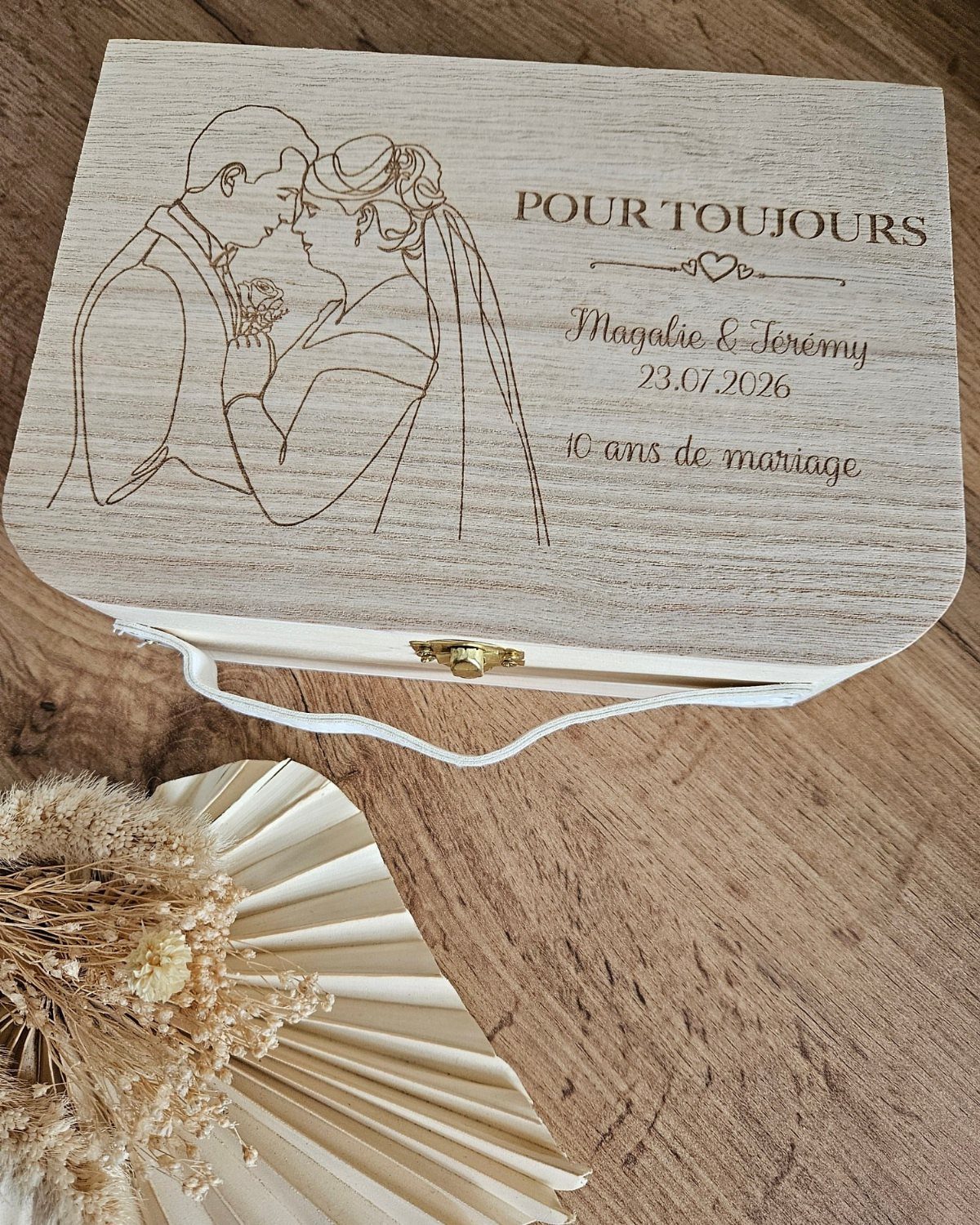 Engraved wooden keepsake box celebrating 10 years of marriage with a couple's illustration.