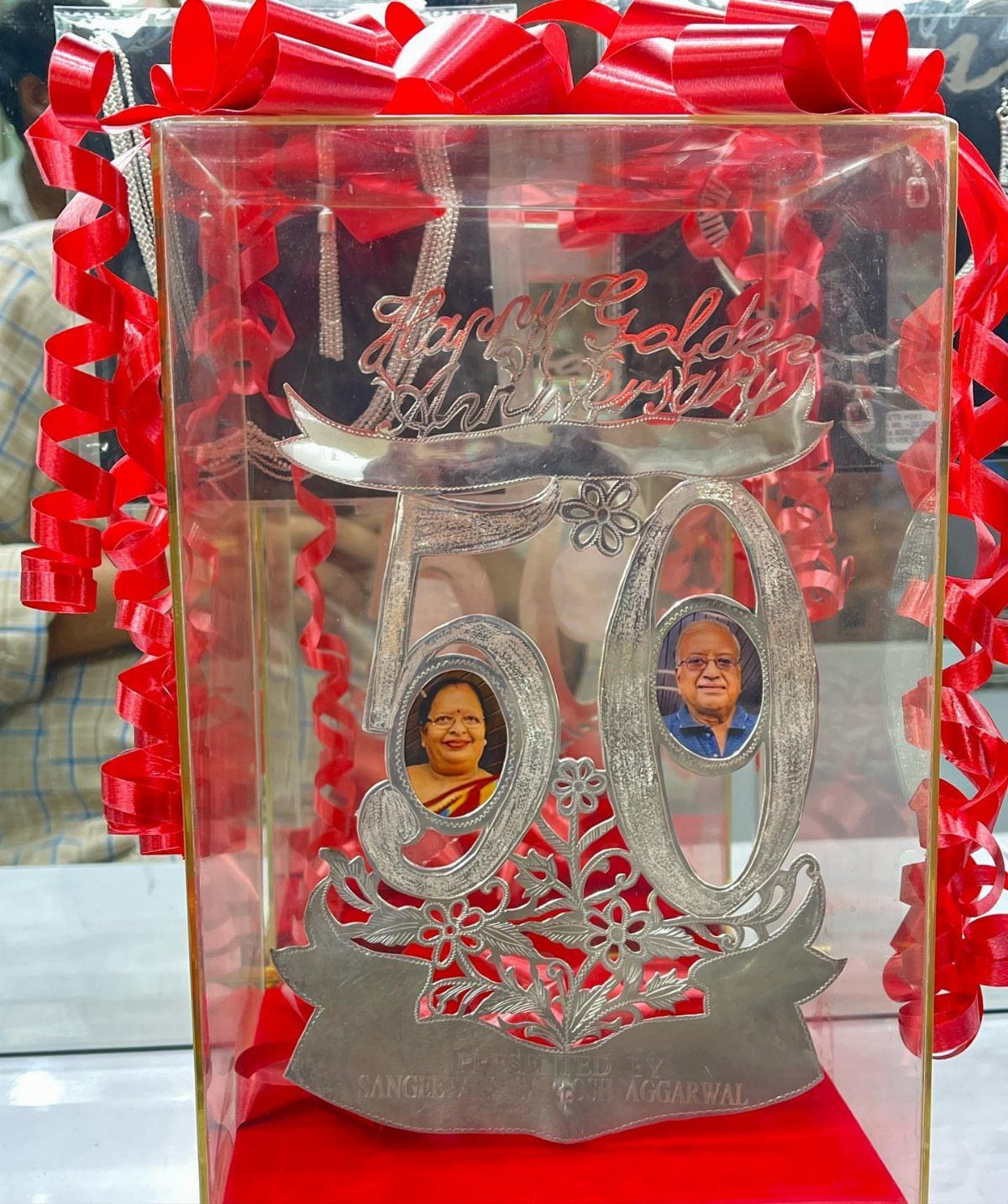 Silver anniversary plaque with number 50 and couple's photos in a clear case