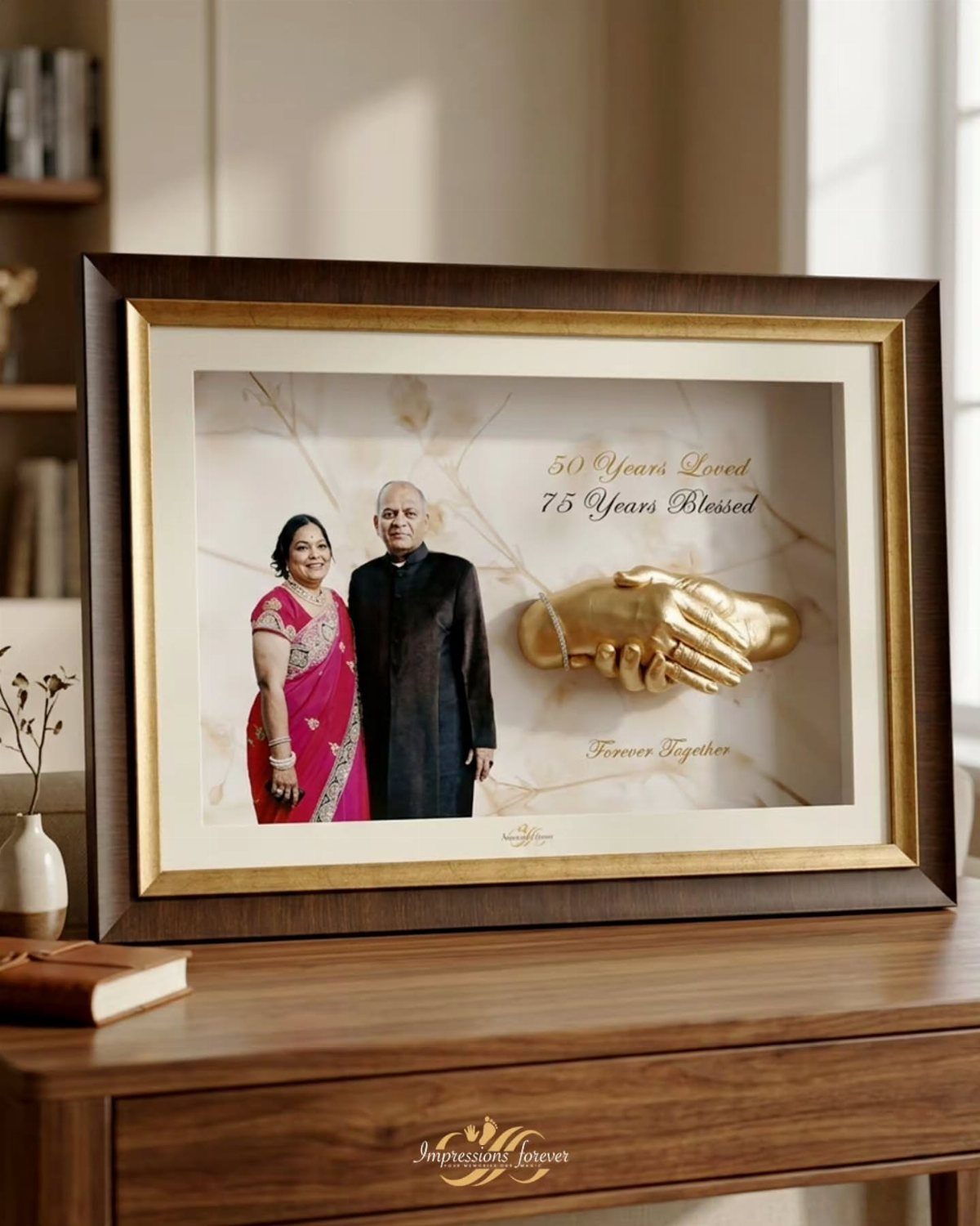 Framed 3D shadow box with elderly couple photo and gold holding hands sculpture.