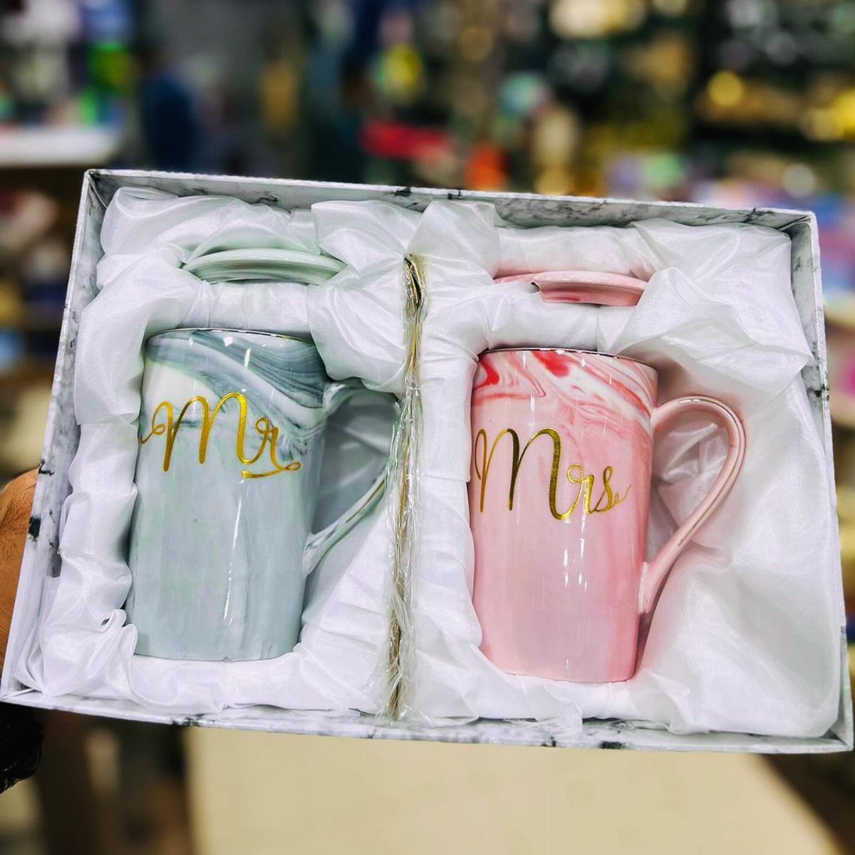 Two marbled ceramic mugs labeled Mr and Mrs in gold inside a gift box.
