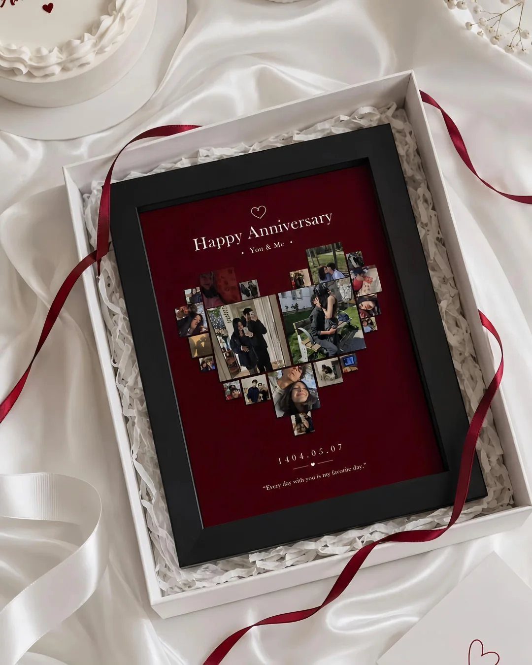 Black picture frame with heart-shaped photo collage in a white gift box.