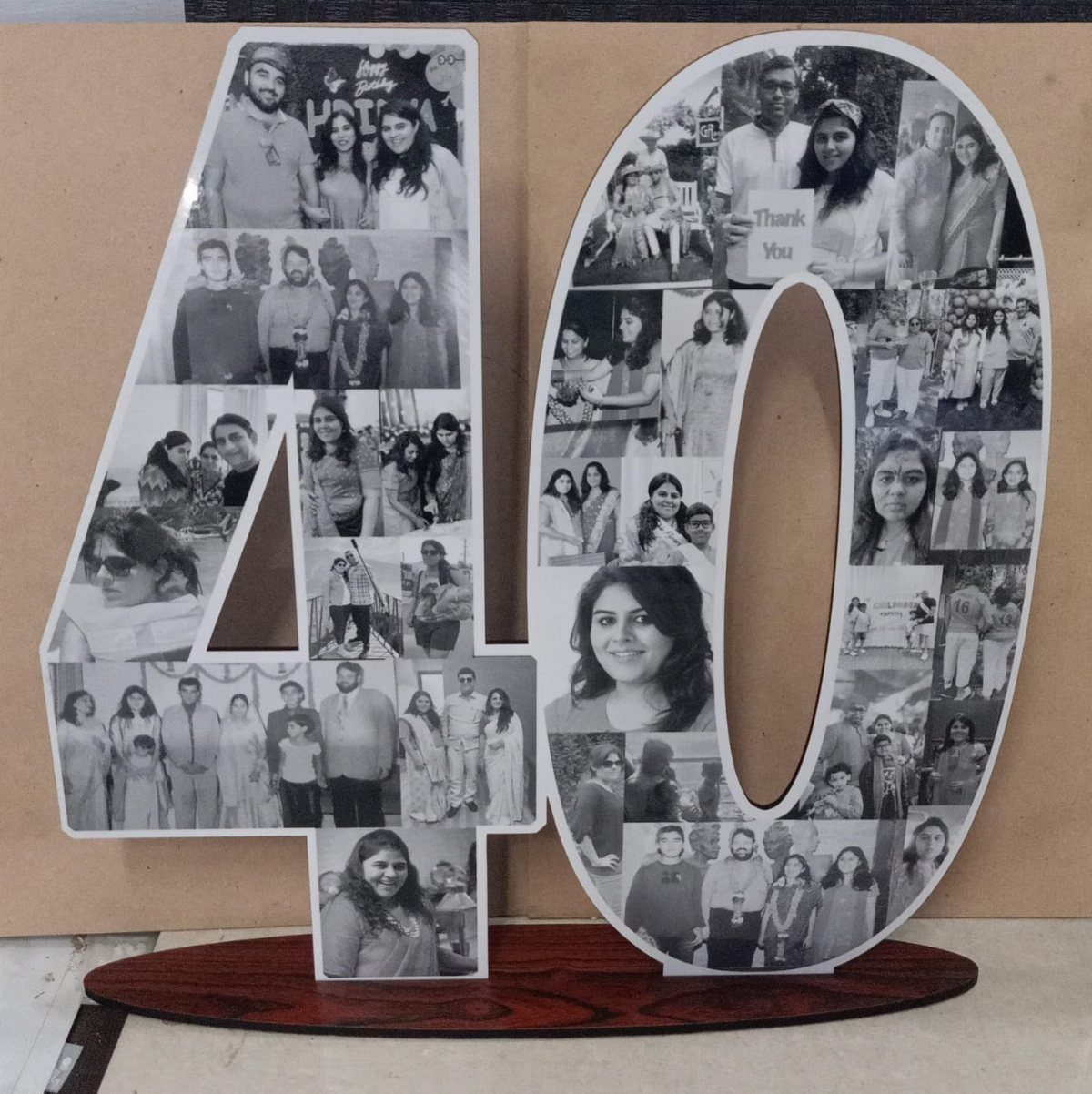 Number 40 photo collage gift standing on a dark wooden base