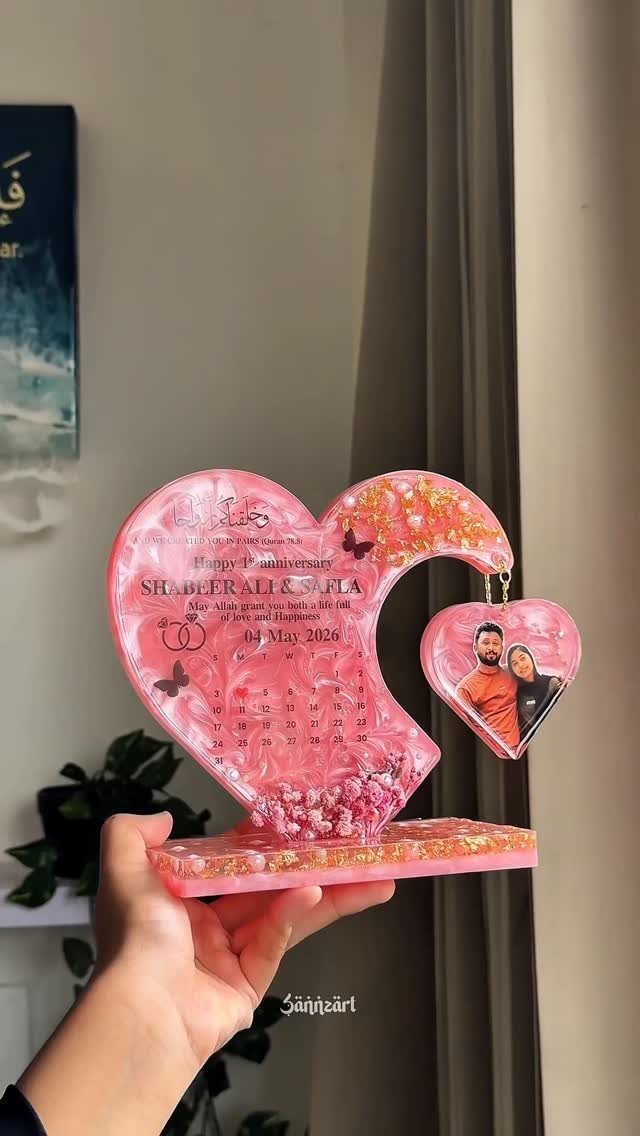 Pink resin heart plaque with a couple's photo and anniversary date details.