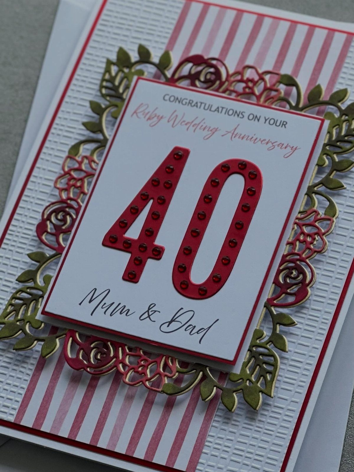 Handmade 40th anniversary card with red glittery numbers and gold floral frame.
