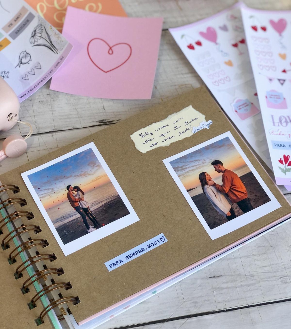 Open brown scrapbook with polaroid photos of a couple and handwritten notes.