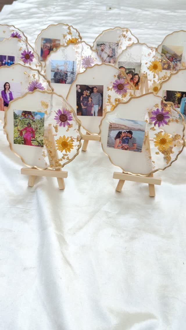 Resin photo discs with gold edges and pressed flowers on wooden easels