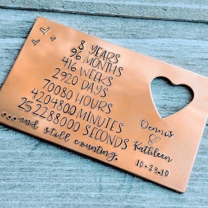 Copper metal plaque with engraved anniversary time counts and a heart cutout.