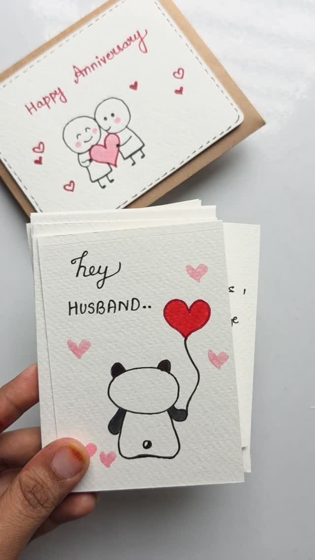 Handmade anniversary cards featuring a panda with a heart balloon and a couple.