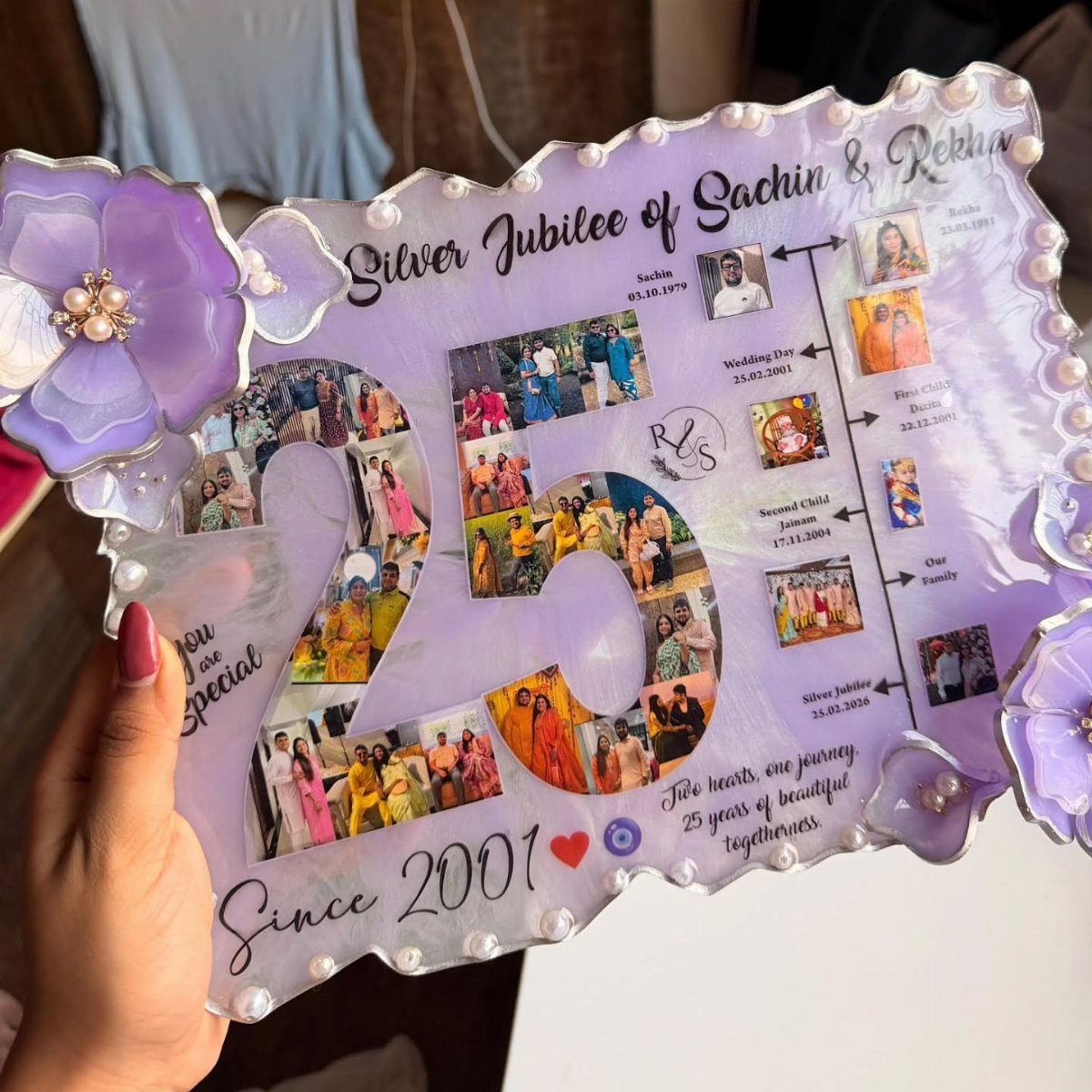 Purple resin anniversary plaque with family photos and text celebrating a silver jubilee.
