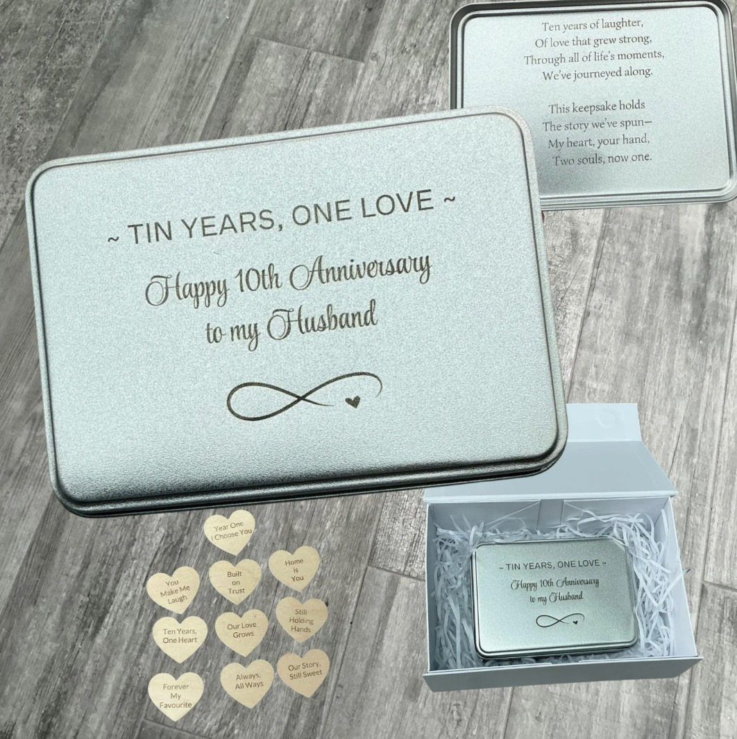 Silver anniversary tin box with heart-shaped wooden tokens on a grey wooden background