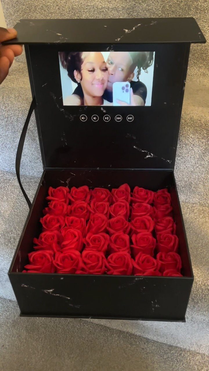 Black marble gift box filled with red roses and a digital photo screen.
