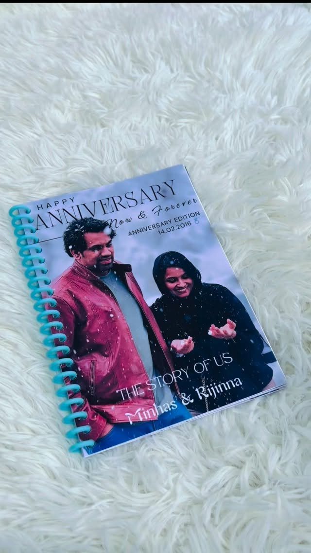 Spiral-bound anniversary photo album with a couple on the cover on white fur.