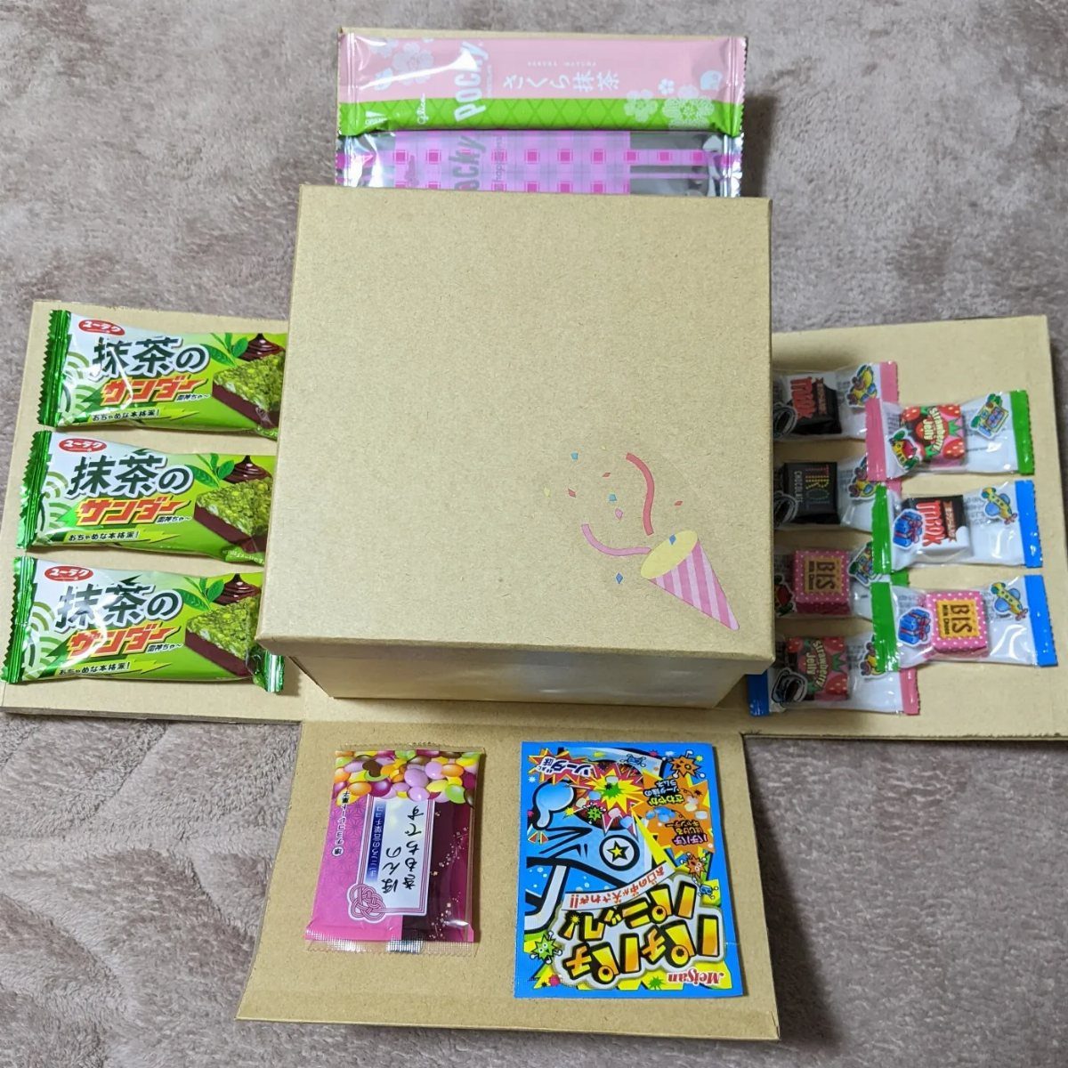Japanese snack box assortment with various colorful candies and green tea treats.