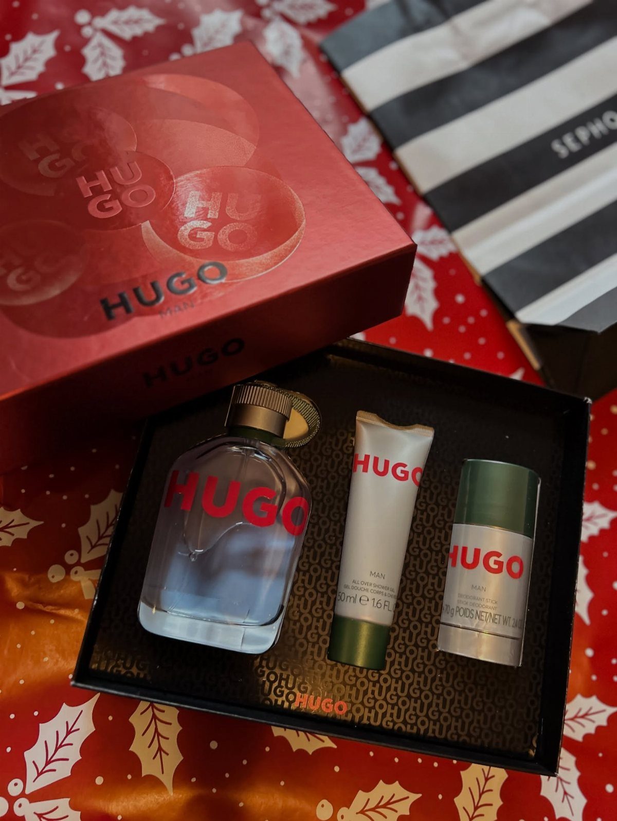 Hugo Boss cologne gift set with fragrance and grooming products on red holiday fabric