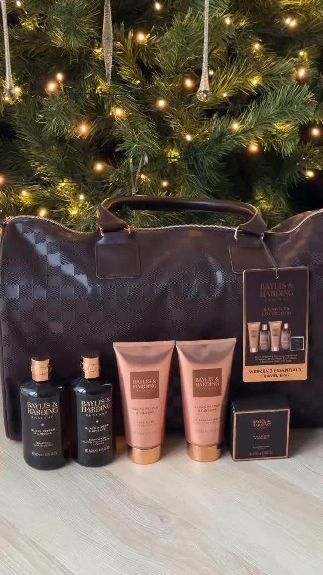 Brown checkered duffel bag and grooming kit in front of a lit Christmas tree