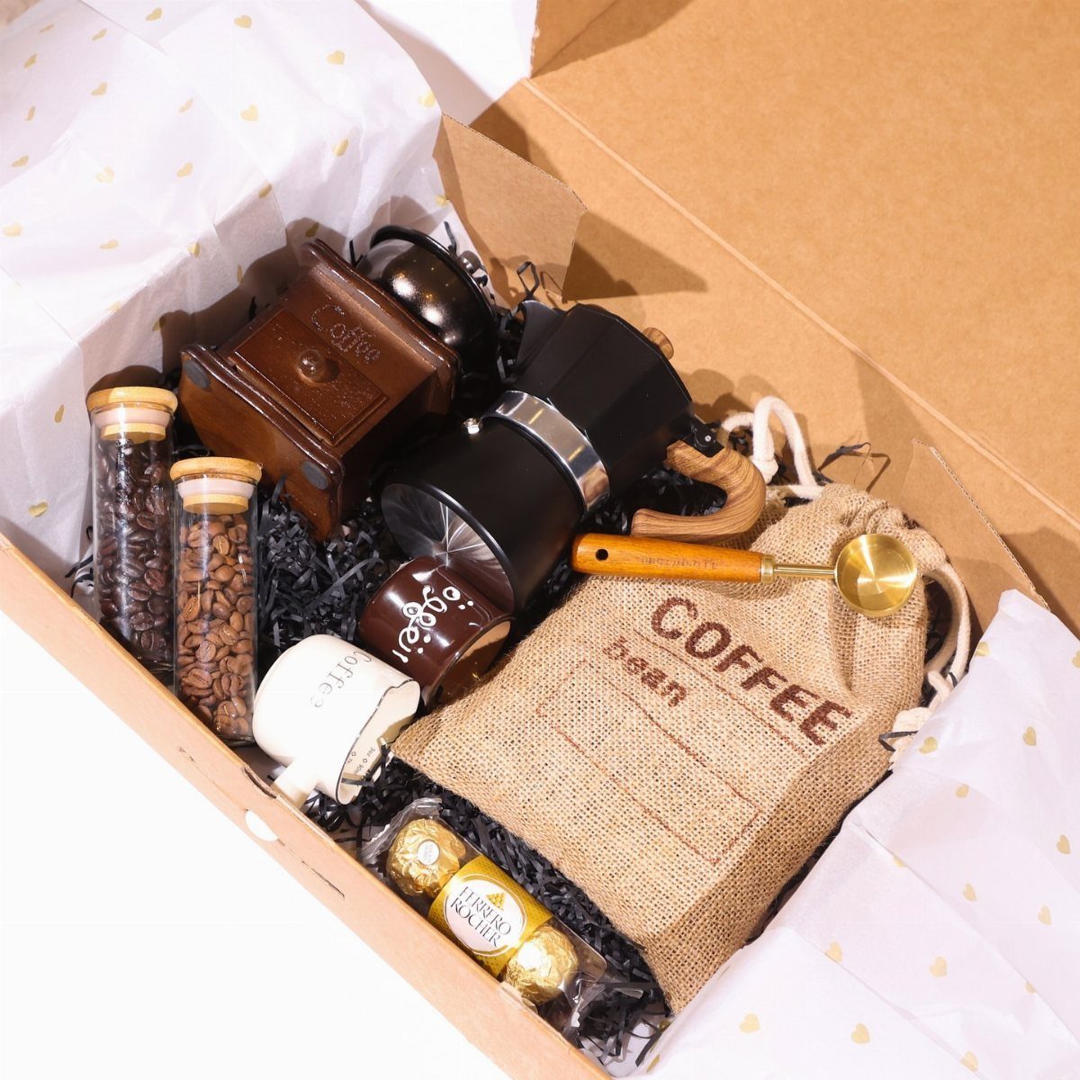 Coffee gift set in a box with grinder, Moka pot, and coffee beans.