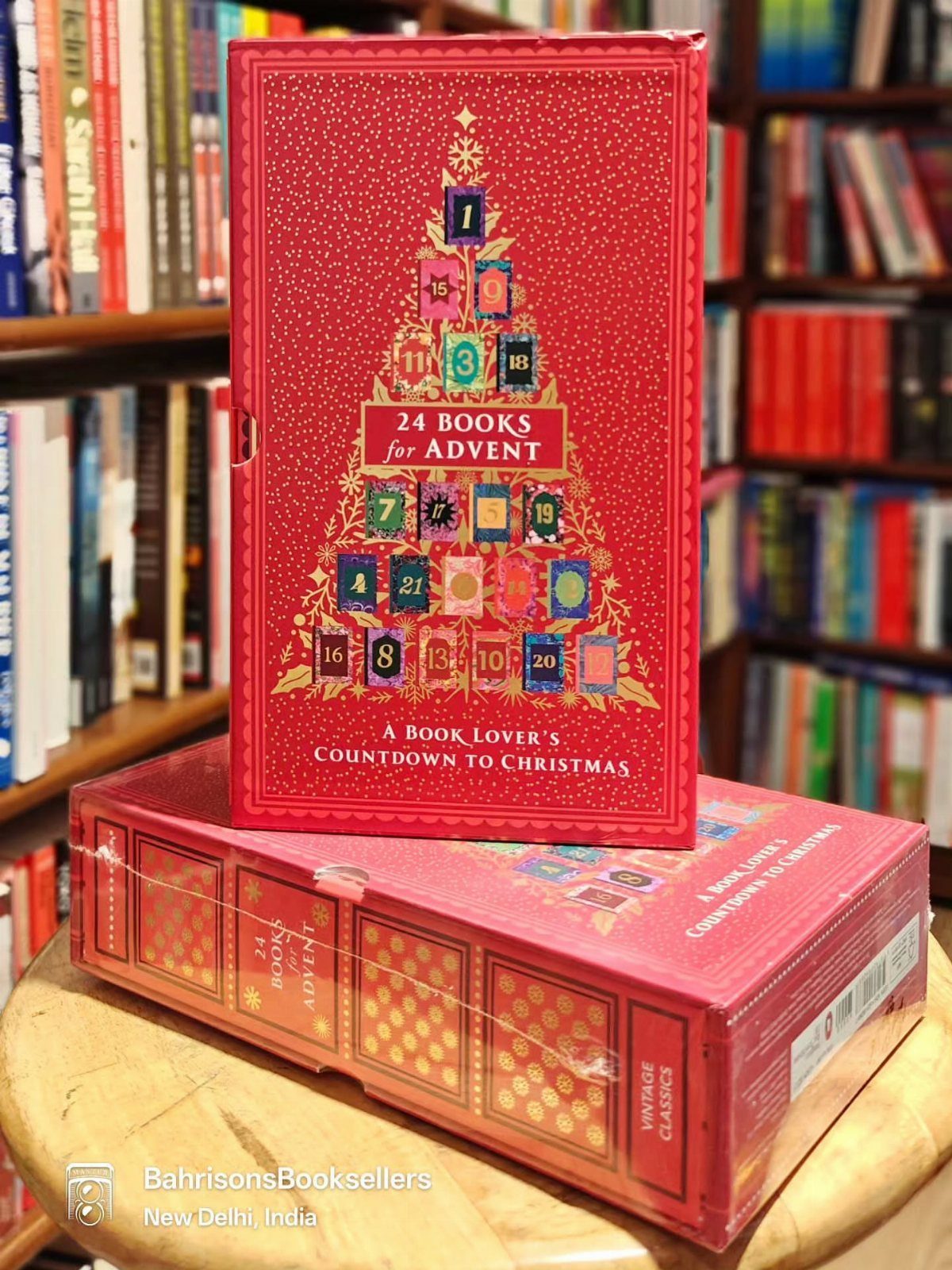 Red 24 Books for Advent calendar box sitting on a wooden surface.