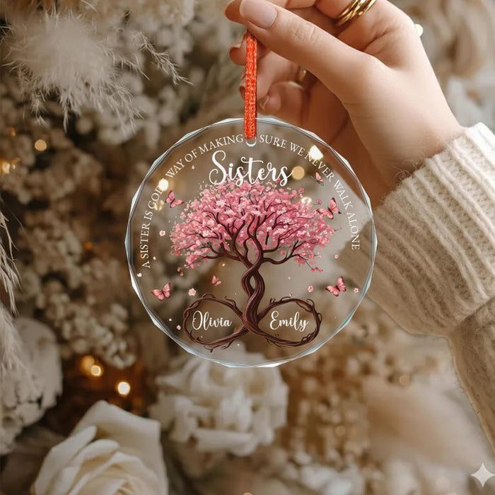 Clear acrylic Christmas ornament with a pink tree and names for sisters.