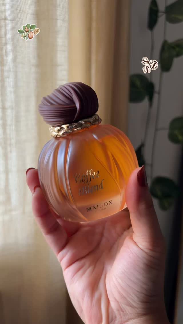 19 Coffee Fan Gifts for Every Budget and Brew Style 14 Amber glass perfume bottle labeled Coffee Blend held in a person's hand.