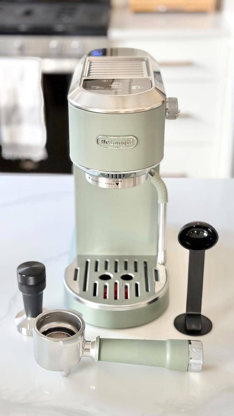 19 Coffee Fan Gifts for Every Budget and Brew Style 1 Light green espresso machine with portafilter and tamper on a white marble counter