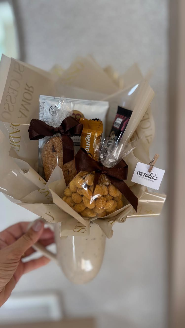 19 Coffee Fan Gifts for Every Budget and Brew Style 18 Beige ceramic mug filled with a bouquet of cookies and snacks as a gift.