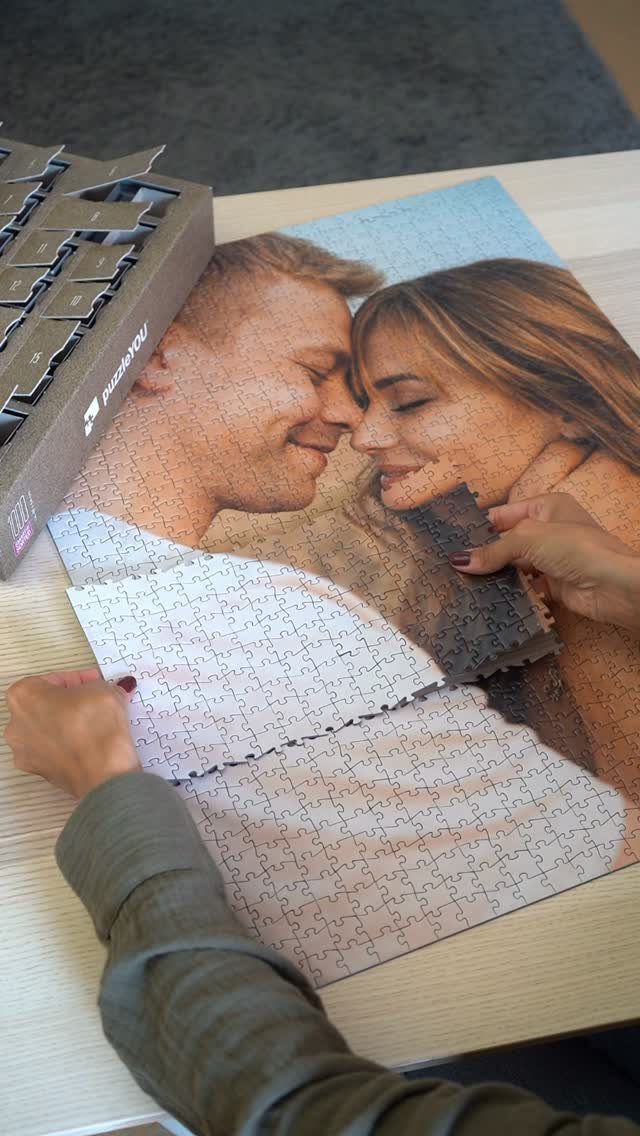 Custom jigsaw puzzle of a couple being assembled on a wooden table