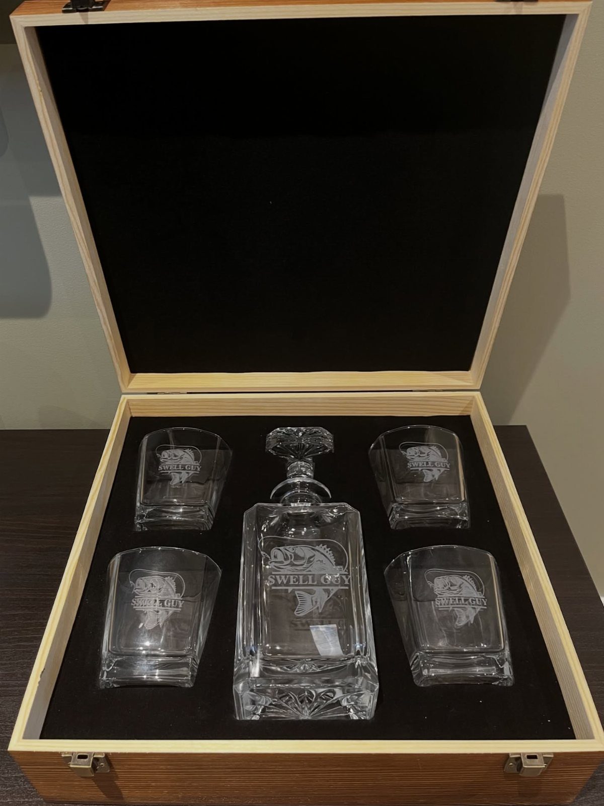 Glass decanter and four matching glasses in a wooden gift box with black lining