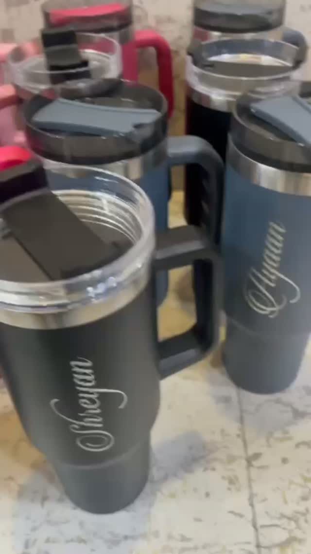 Custom Engraved Gifts: 10 Ideas for Every Occasion 7 Dark grey insulated tumblers with cursive names engraved on the side.
