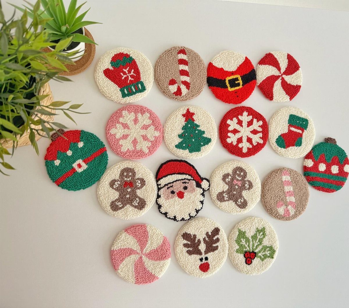 Crocheted Christmas coasters with festive designs arranged on a white background.