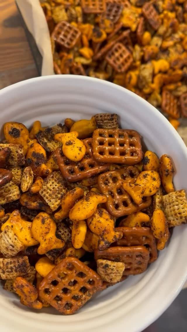 Savory snack mix with pretzels and fish crackers in a white bowl