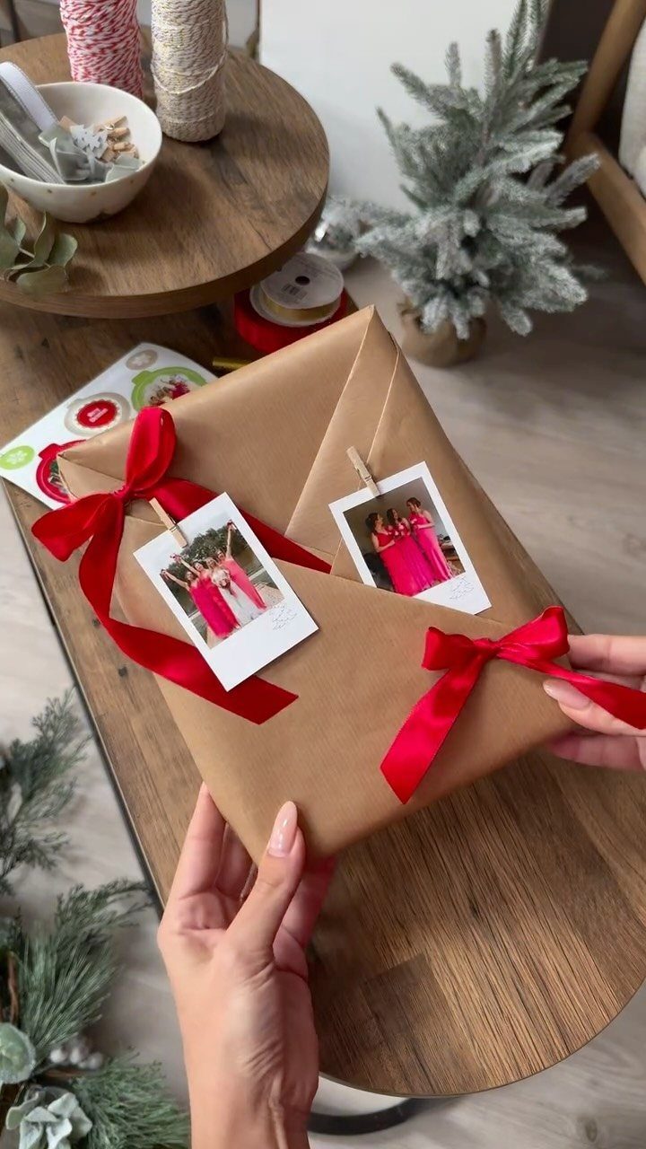 Brown paper wrapped gifts with red ribbons and polaroid photos attached by clothespins.