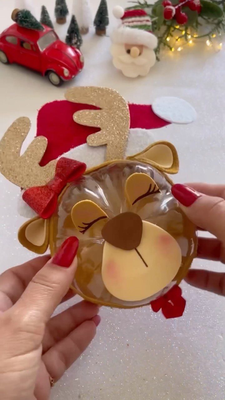 Reindeer-themed DIY gift container made from a plastic bottle and colorful felt decorations.