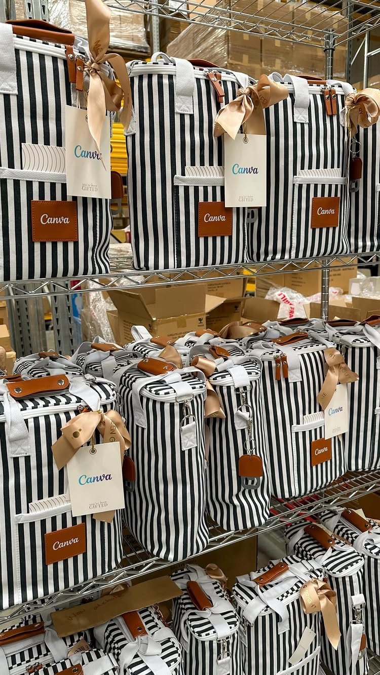 Striped tote bags with Canva branding and tan ribbons on metal warehouse shelves