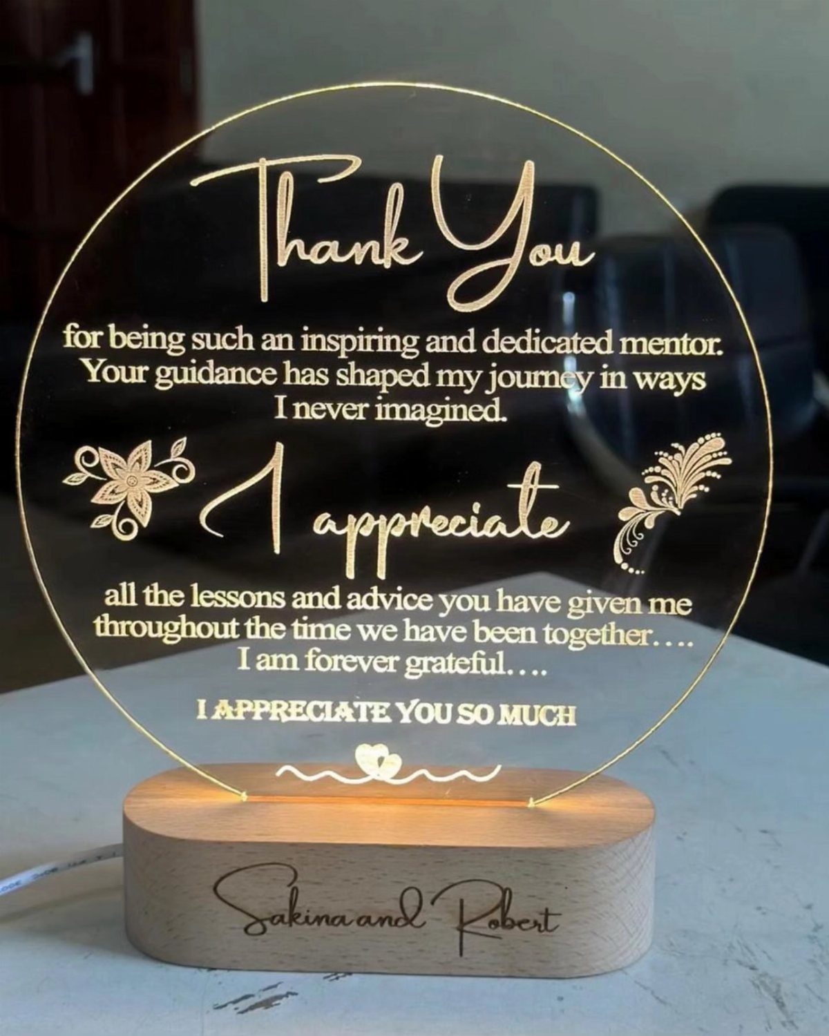 Engraved acrylic thank you plaque on a wooden base with gold lettering.