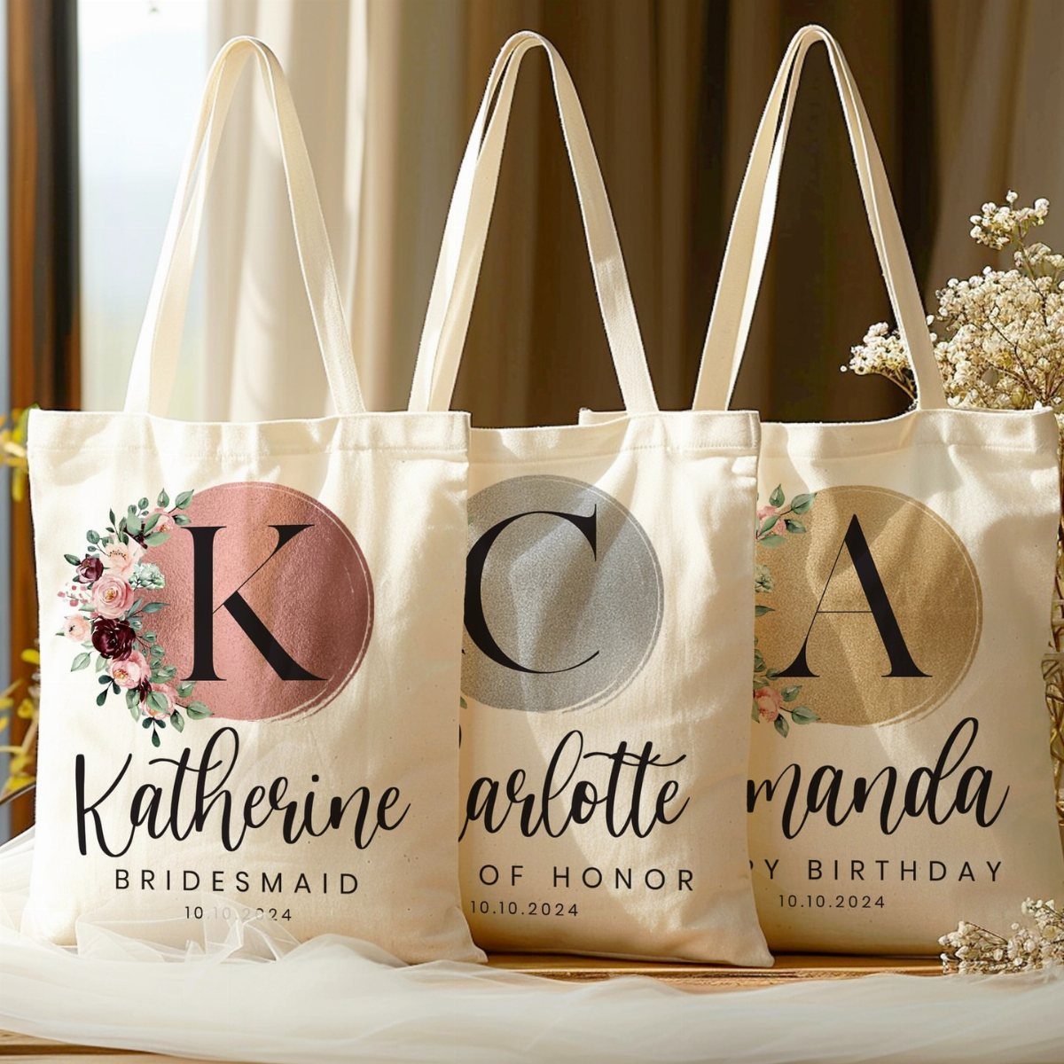 Three personalized canvas tote bags with floral designs and names for bridal party.