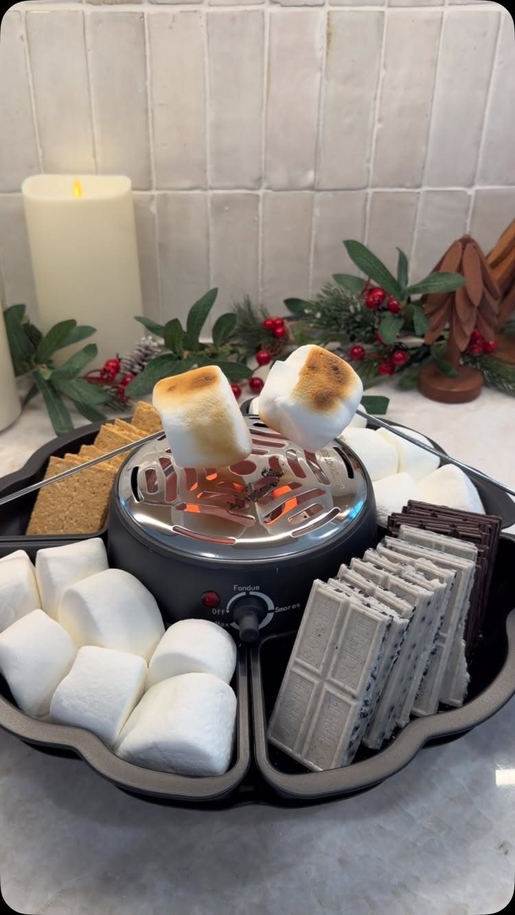 Electric s'mores maker with marshmallows, chocolate, and graham crackers for a family treat.