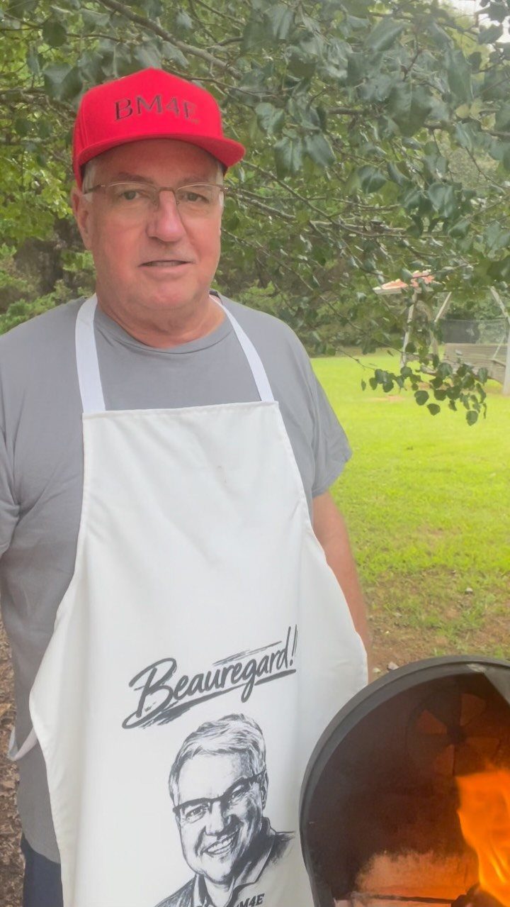22 Gift Ideas for Brother, From Hoodies to Gadgets 20 Man in a red cap and custom caricature apron standing by a fire pit.