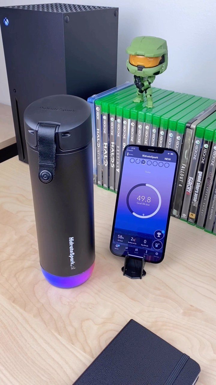 22 Gift Ideas for Brother, From Hoodies to Gadgets 17 Smart water bottle and gaming accessories arranged on a light wooden desk.