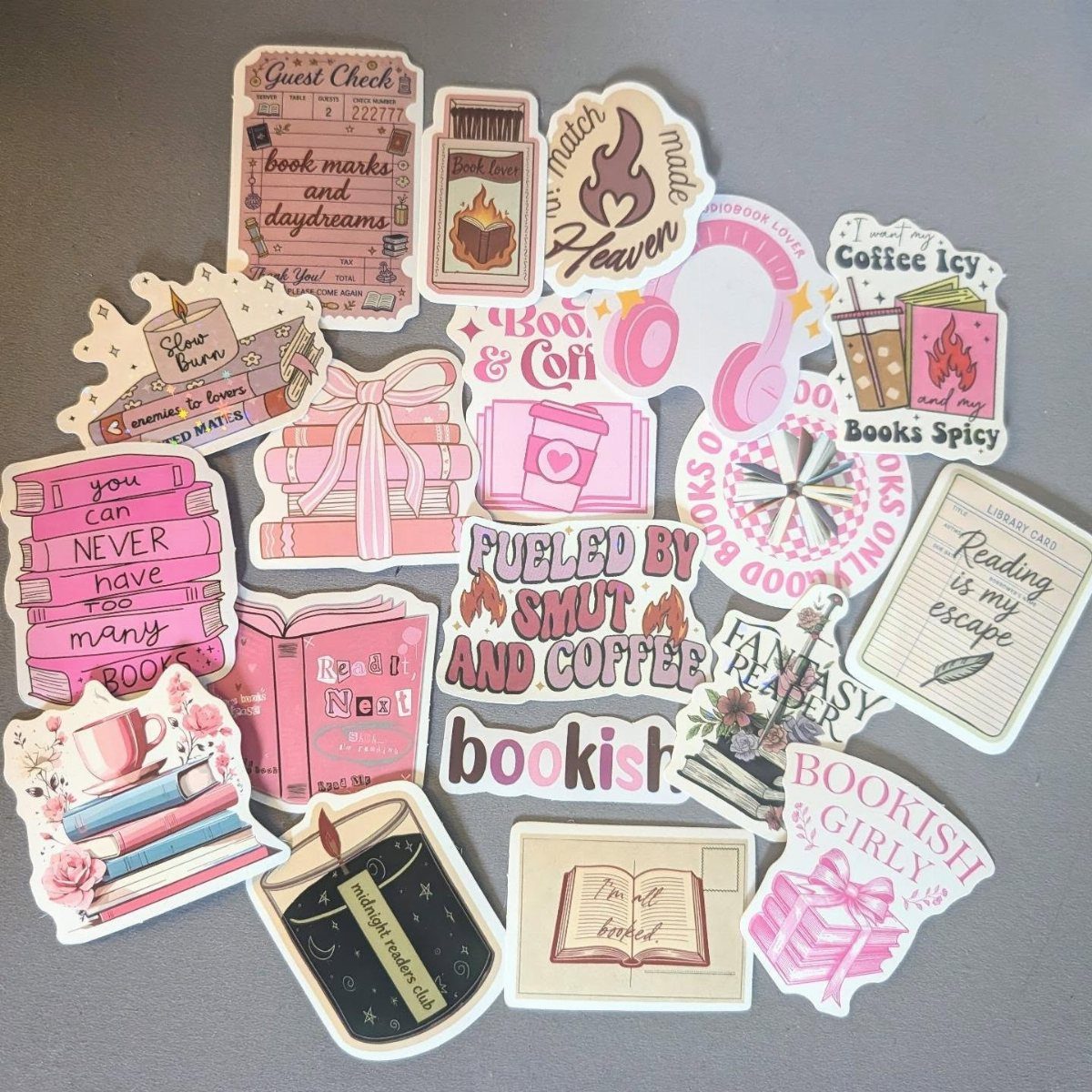 Assorted bookish stickers with literary quotes and illustrations on a grey background.