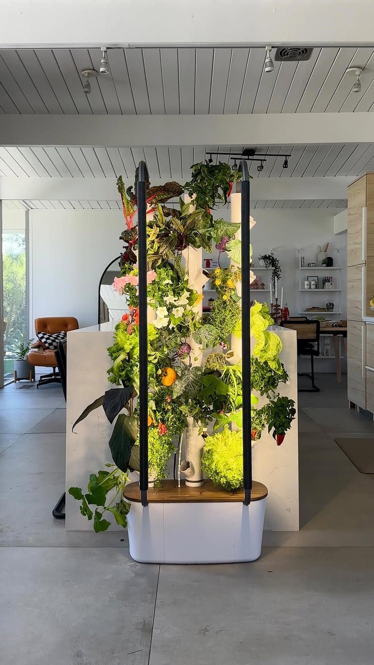 Vertical hydroponic garden tower with lush green herbs in a modern indoor setting