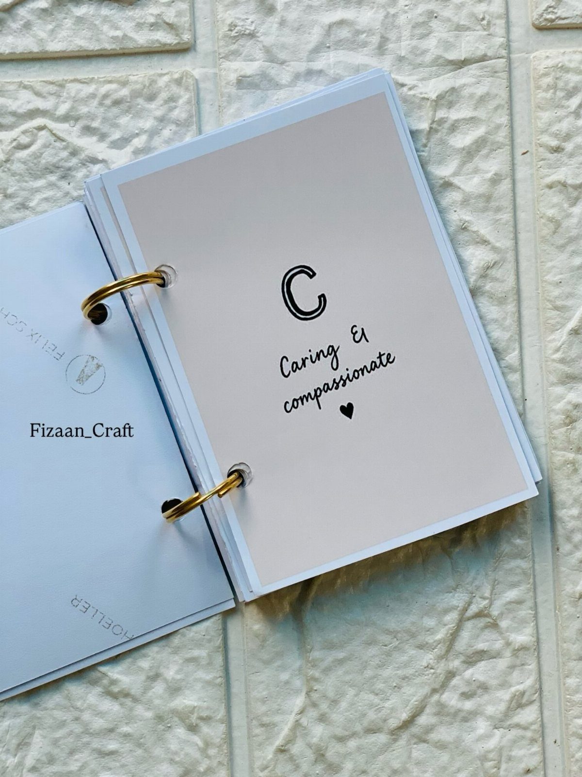 Handmade ring-bound book with a personalized page describing caring and compassionate traits.