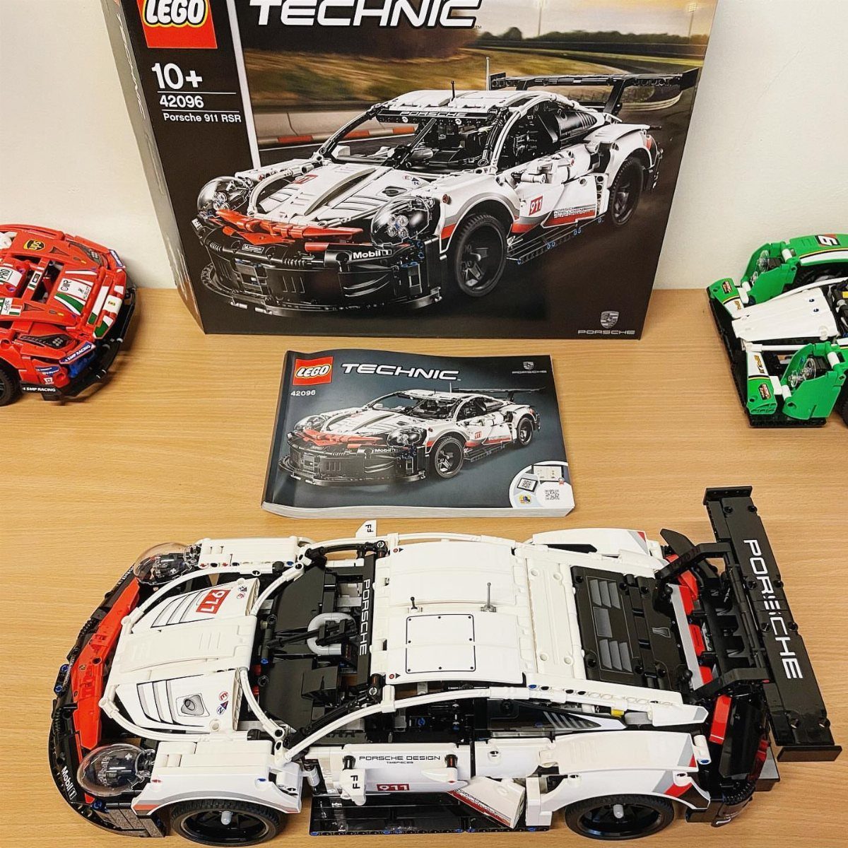 White LEGO Technic Porsche 911 RSR model car with its box and manual.