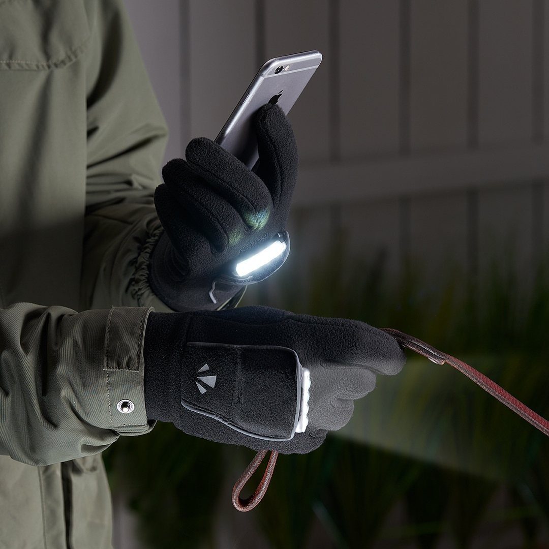 Black athletic gloves with an attached LED light holding a phone and leash