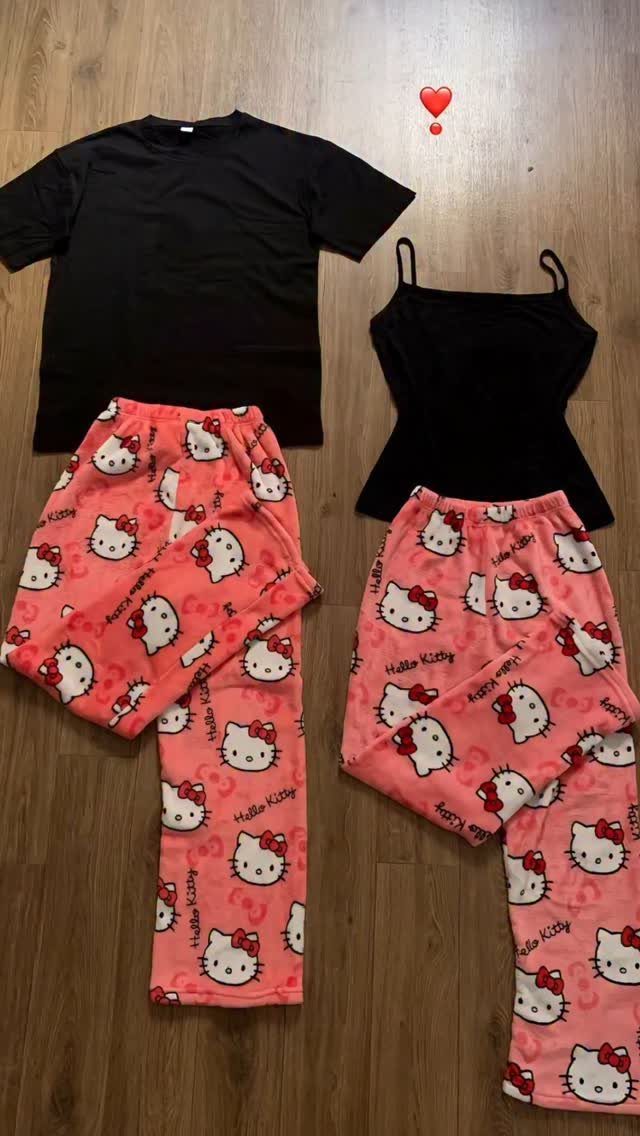 Two pajama sets with black tops and pink Hello Kitty fleece pants on wood.
