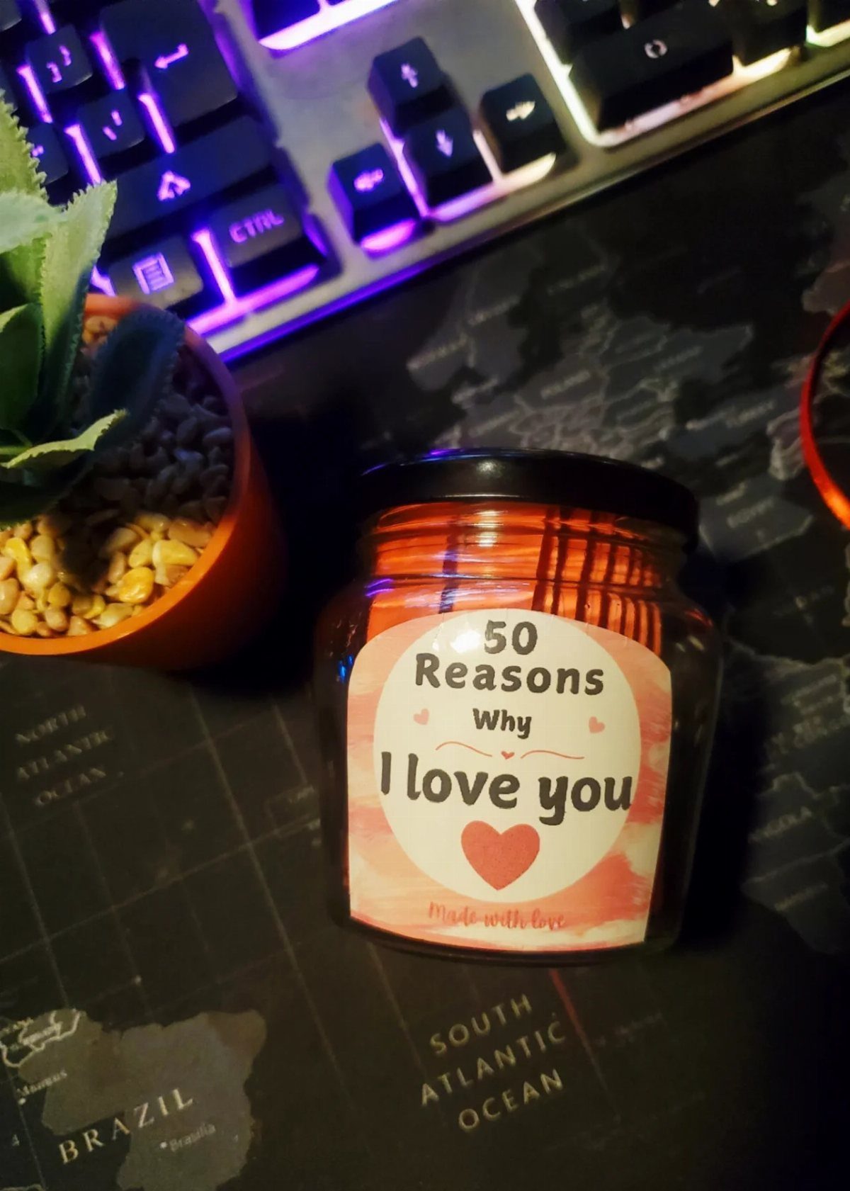 Glass jar filled with orange notes labeled 50 Reasons Why I love you