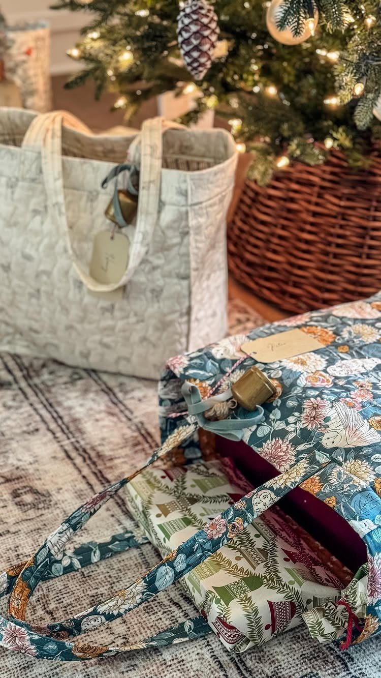 Two quilted tote bags on a rug in front of a Christmas tree