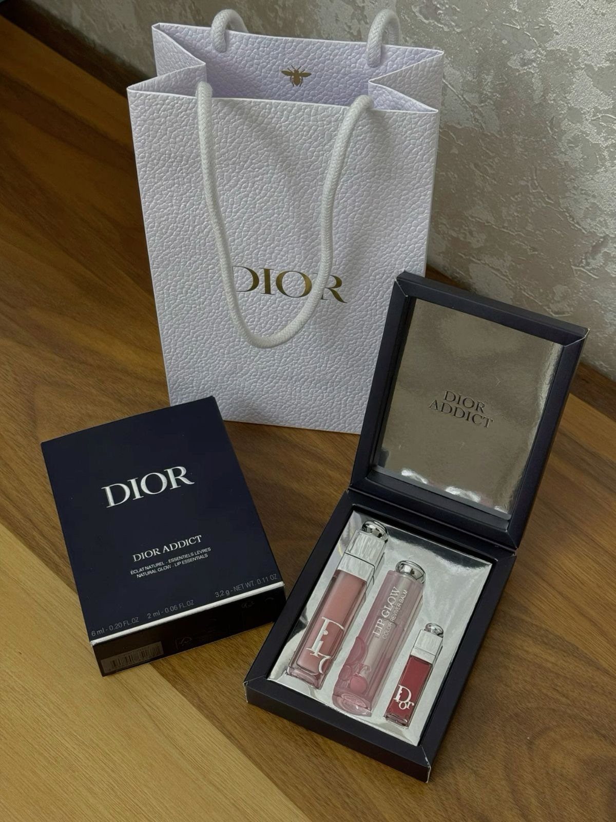 Dior lip gloss set in a black gift box with a white shopping bag.
