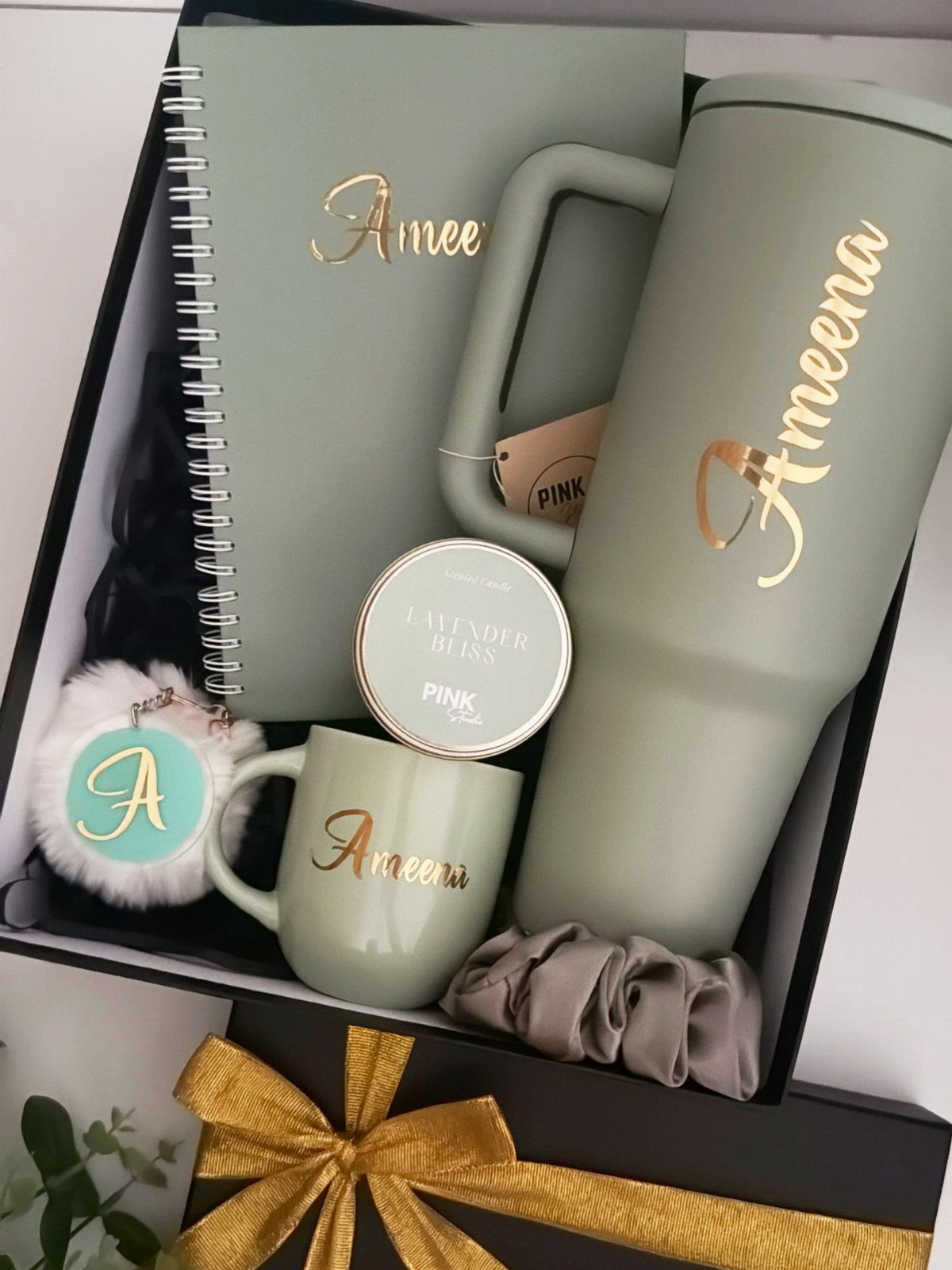 Sage green personalized gift set with tumbler, notebook, and mug in a black box