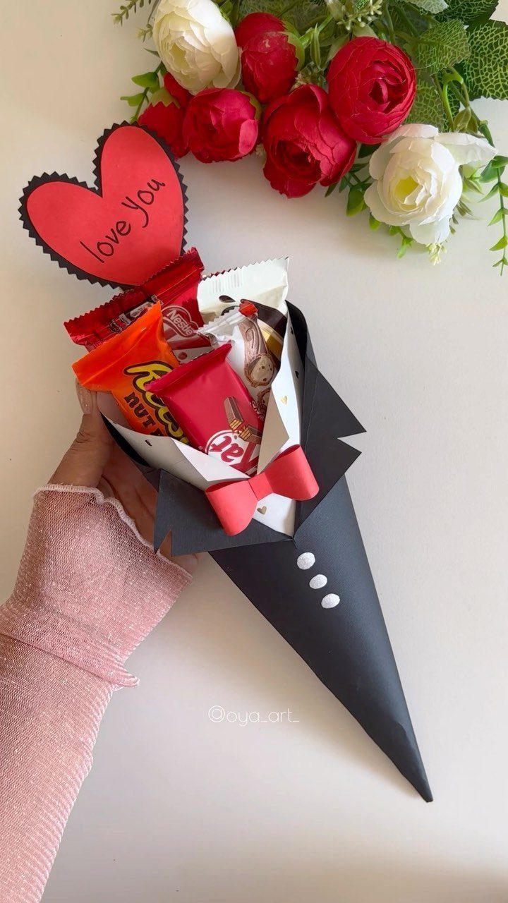Candy bouquet wrapped as a tuxedo with a red heart and chocolates.