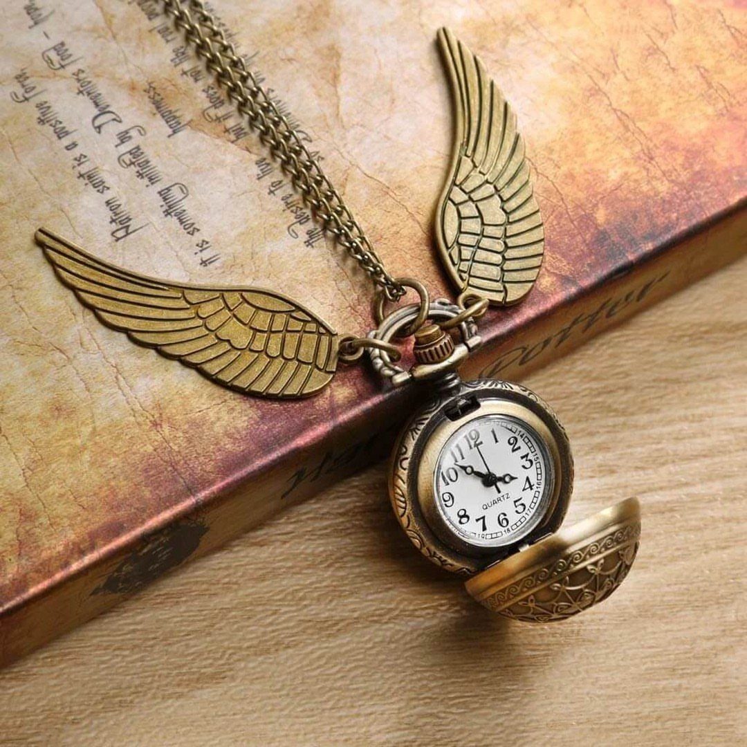 25 Best Harry Potter Gifts for Every Wizarding Fan in 2026 18 Golden Snitch pocket watch with wings resting on a vintage handwritten book